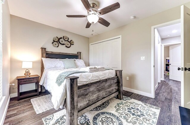 bedroom with wood finished floors, a closet, baseboards, and ceiling fan