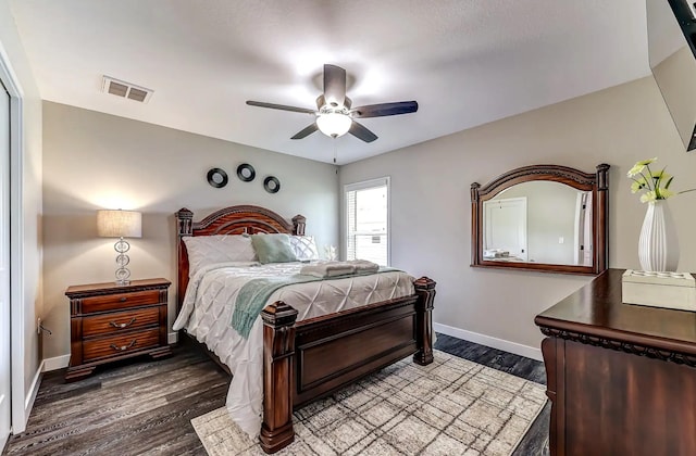 bedroom featuring baseboards, dark wood finished floors, and ceiling fan