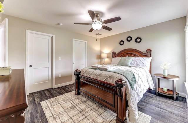 bedroom with wood finished floors, a ceiling fan, and baseboards