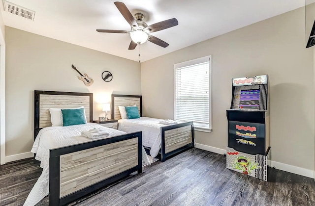 bedroom with wood finished floors, baseboards, and ceiling fan