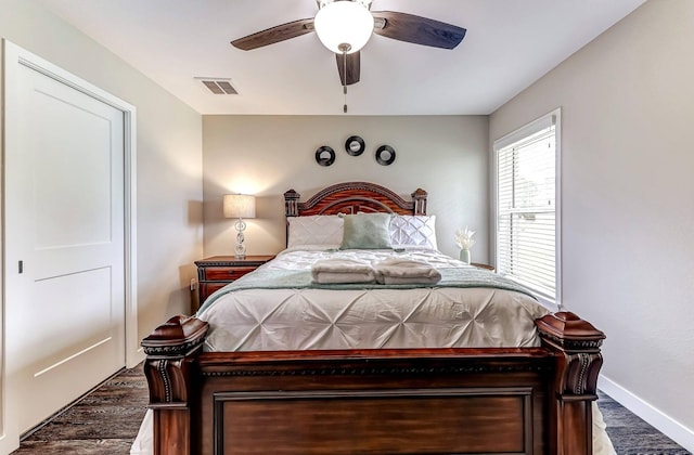 bedroom with wood finished floors, baseboards, and ceiling fan