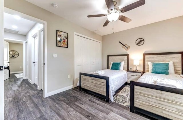 bedroom featuring wood finished floors, a closet, baseboards, and ceiling fan
