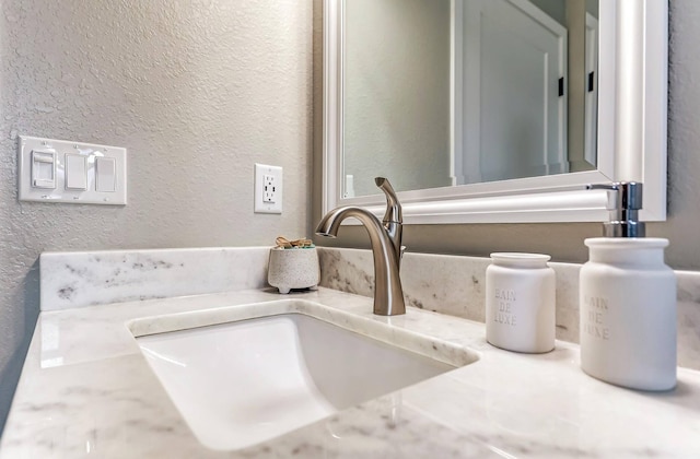bathroom view of a textured wall and vanity