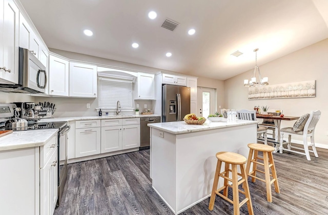 kitchen featuring stainless steel appliances, dark wood-type flooring, a sink, white cabinetry, and recessed lighting