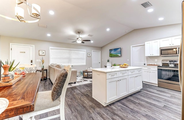 kitchen featuring appliances with stainless steel finishes, dark wood-style flooring, white cabinetry, open floor plan, and ceiling fan