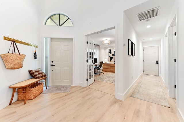 foyer entrance with light wood finished floors and baseboards