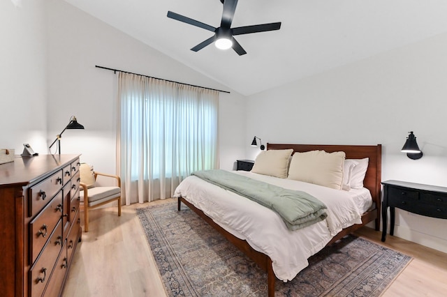bedroom with light wood-style flooring, lofted ceiling, and ceiling fan