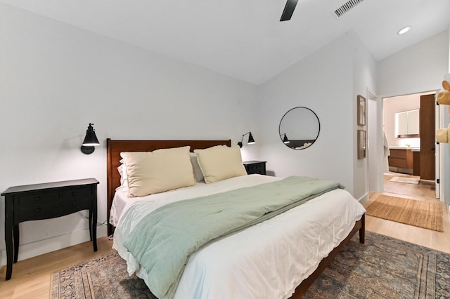 bedroom featuring lofted ceiling, wood finished floors, baseboards, recessed lighting, and a ceiling fan