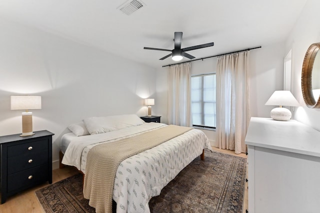 bedroom with light wood-style floors and a ceiling fan