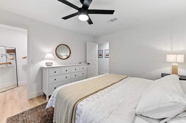 bedroom featuring light wood-type flooring, baseboards, and ceiling fan