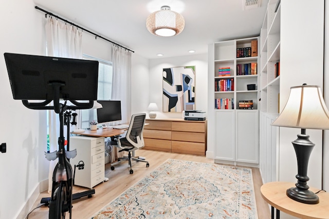 office area featuring light wood finished floors and baseboards