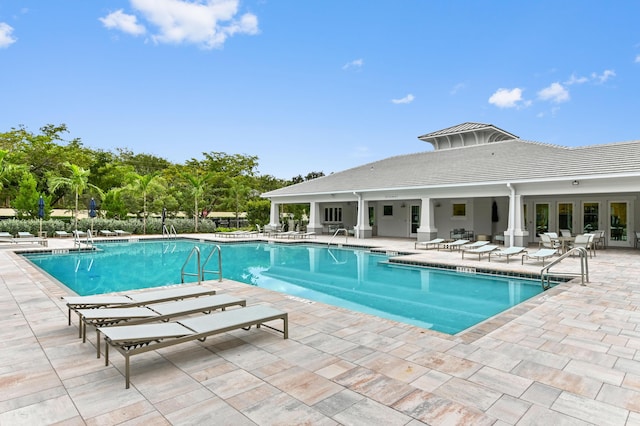 community pool with a patio and french doors