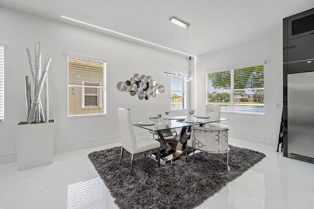 682 Cresta Cir, West Palm Beach, FL 33413 - dining space with light tile patterned flooring and baseboards