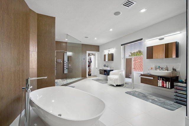 682 Cresta Cir, West Palm Beach, FL 33413 - full bath with a freestanding tub, tiled shower, a sink, recessed lighting, and tile patterned floors