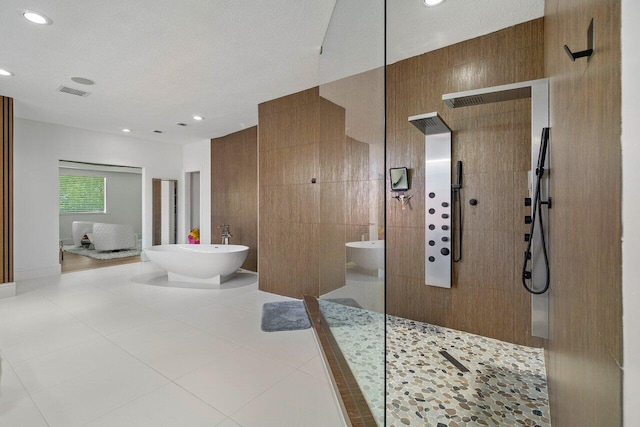 682 Cresta Cir, West Palm Beach, FL 33413 - bathroom featuring a freestanding tub, walk in shower, recessed lighting, and tile patterned flooring