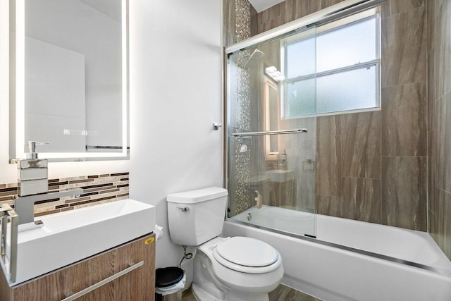 682 Cresta Cir, West Palm Beach, FL 33413 - full bath featuring tasteful backsplash, toilet, bath / shower combo with glass door, and vanity
