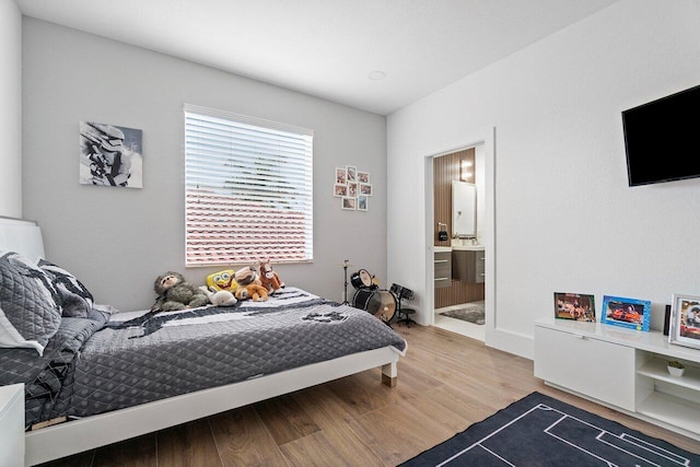 682 Cresta Cir, West Palm Beach, FL 33413 - bedroom with wood finished floors and connected bathroom