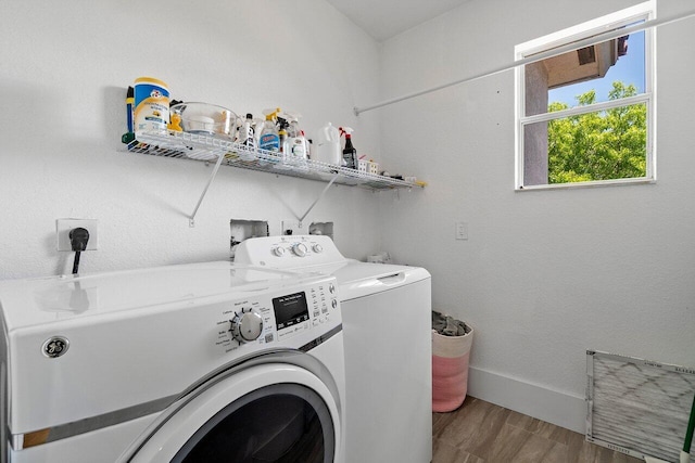 682 Cresta Cir, West Palm Beach, FL 33413 - washroom with wood finished floors, separate washer and dryer, and baseboards