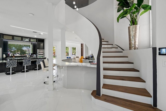 682 Cresta Cir, West Palm Beach, FL 33413 - staircase with tile patterned floors and recessed lighting