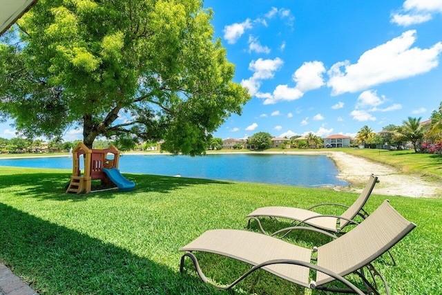 682 Cresta Cir, West Palm Beach, FL 33413 - surrounding community with a yard and a water view