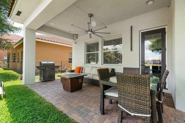 682 Cresta Cir, West Palm Beach, FL 33413 - view of patio with fence, area for grilling, a ceiling fan, and an outdoor living space with a fire pit