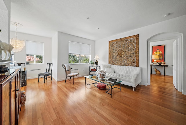 11011 Legacy Ln Unit 306, Palm Beach Gardens, FL 33410 - living room with light wood finished floors, a chandelier, and baseboards