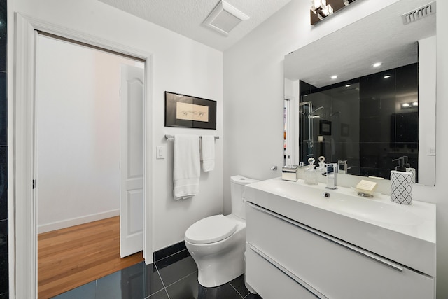 11011 Legacy Ln Unit 306, Palm Beach Gardens, FL 33410 - bathroom with a stall shower, tile patterned flooring, toilet, vanity, and baseboards