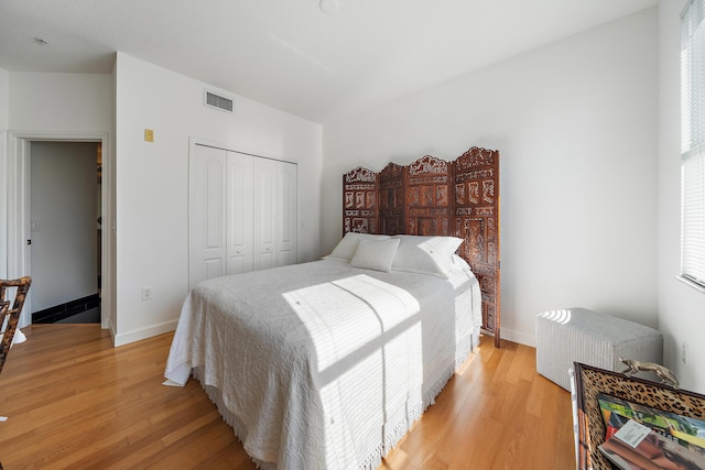 11011 Legacy Ln Unit 306, Palm Beach Gardens, FL 33410 - bedroom featuring a closet, light wood finished floors, baseboards, and radiator heating unit