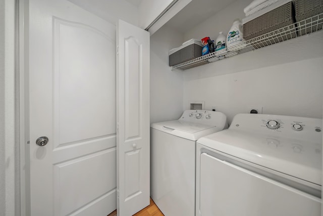 11011 Legacy Ln Unit 306, Palm Beach Gardens, FL 33410 - laundry area featuring washer and clothes dryer and light wood-style floors