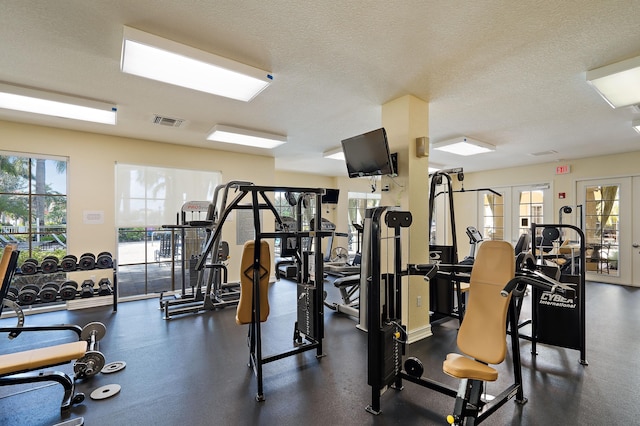 11011 Legacy Ln Unit 306, Palm Beach Gardens, FL 33410 - exercise room featuring plenty of natural light and a textured ceiling