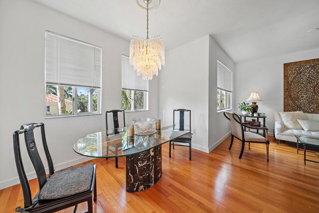 11011 Legacy Ln Unit 306, Palm Beach Gardens, FL 33410 - dining space with a chandelier, healthy amount of natural light, wood finished floors, and baseboards