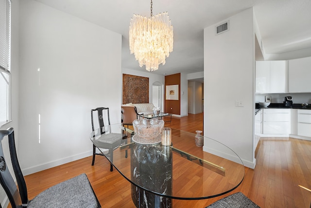 11011 Legacy Ln Unit 306, Palm Beach Gardens, FL 33410 - dining room with a chandelier, light wood-style flooring, and baseboards