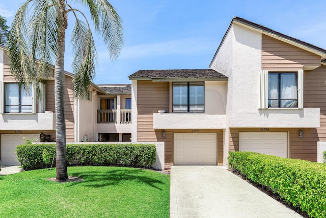 22924 Ironwedge Dr, Boca Raton, FL 33433 - view of property with an attached garage, concrete driveway, a front yard, and stucco siding