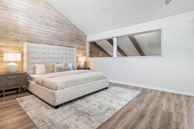 22924 Ironwedge Dr, Boca Raton, FL 33433 - bedroom featuring wooden walls, vaulted ceiling, wood finished floors, a textured ceiling, and baseboards