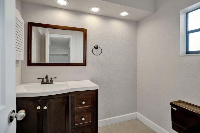bathroom featuring vanity, baseboards, and tile patterned floors