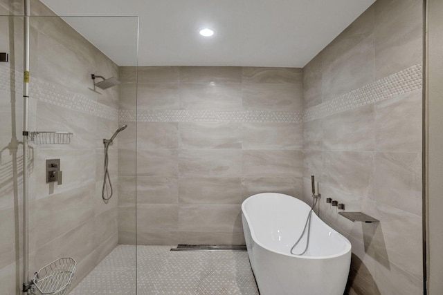 full bathroom with a freestanding tub, tiled shower, and recessed lighting