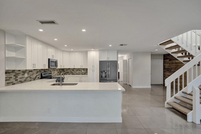 kitchen with appliances with stainless steel finishes, a sink, open shelves, light countertops, and backsplash