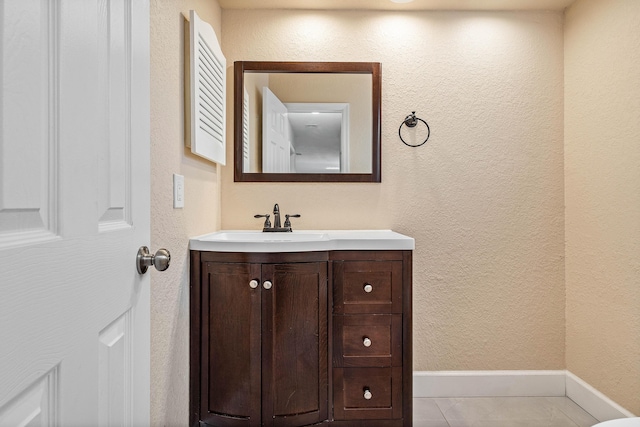 22924 Ironwedge Dr, Boca Raton, FL 33433 - bathroom featuring vanity, a textured wall, baseboards, and tile patterned floors