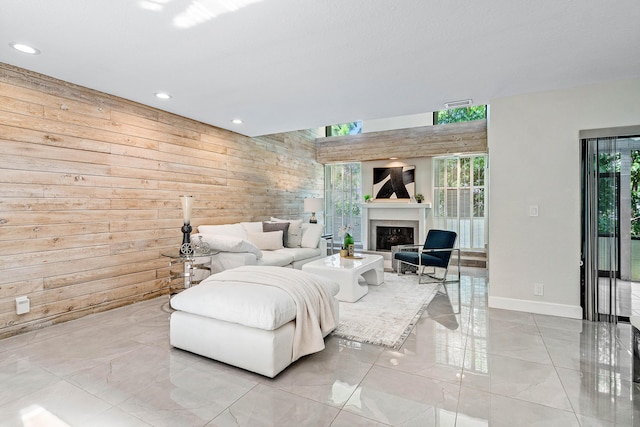 22924 Ironwedge Dr, Boca Raton, FL 33433 - living area featuring wood walls, a fireplace, recessed lighting, and baseboards