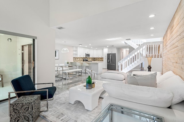 22924 Ironwedge Dr, Boca Raton, FL 33433 - living area with stairway, recessed lighting, wooden walls, and light tile patterned floors