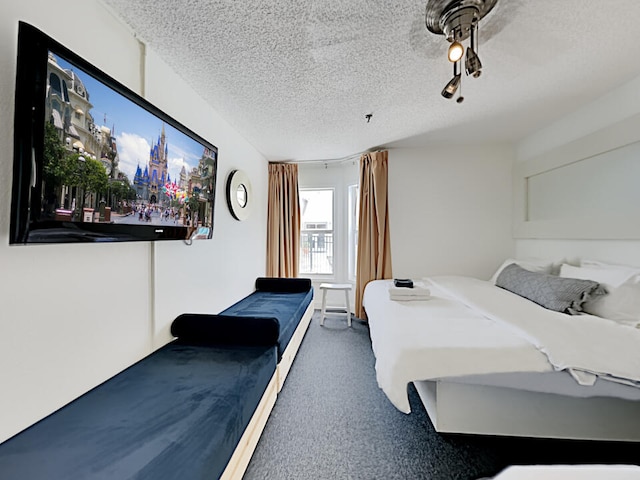 3100 Parkway Blvd Unit 310, Kissimmee, FL 34747 - carpeted bedroom featuring a textured ceiling