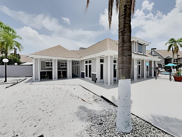 3100 Parkway Blvd Unit 310, Kissimmee, FL 34747 - rear view of property featuring fence, a patio, and a shingled roof