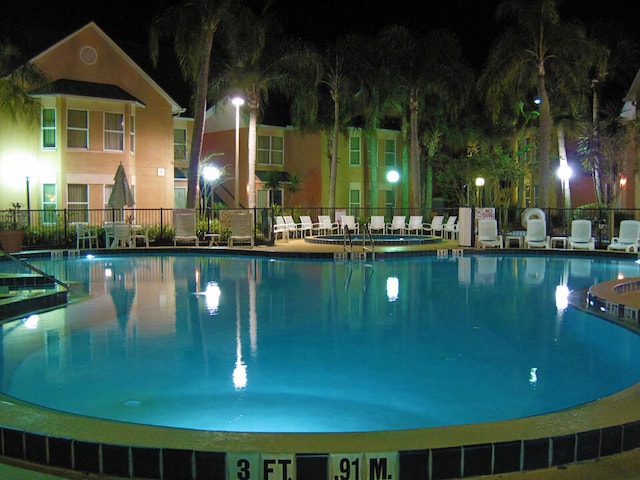 3100 Parkway Blvd Unit 310, Kissimmee, FL 34747 - pool at night with fence and a community pool