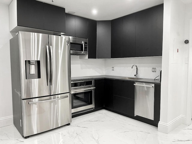 3100 Parkway Blvd Unit 310, Kissimmee, FL 34747 - kitchen with stainless steel appliances, dark cabinets, light marble finish flooring, and modern cabinets
