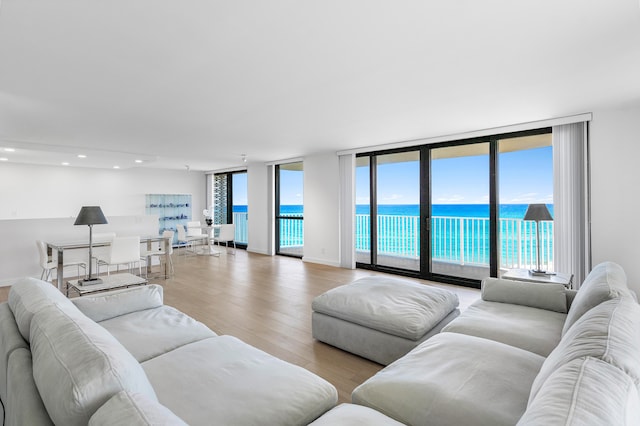 3360 S Ocean Blvd Unit 5Fii, Palm Beach, FL 33480 - living area featuring light wood-style floors, a water view, floor to ceiling windows, plenty of natural light, and recessed lighting