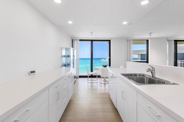 3360 S Ocean Blvd Unit 5Fii, Palm Beach, FL 33480 - kitchen featuring a sink, light countertops, recessed lighting, light wood finished floors, and white cabinetry