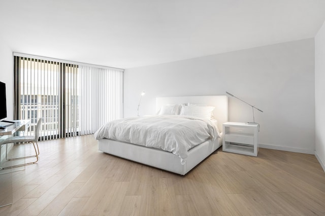 3360 S Ocean Blvd Unit 5Fii, Palm Beach, FL 33480 - bedroom featuring light wood-style floors, expansive windows, and baseboards