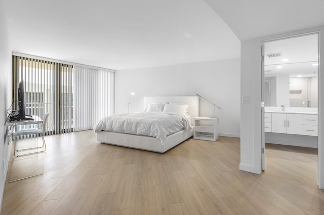 3360 S Ocean Blvd Unit 5Fii, Palm Beach, FL 33480 - bedroom with light wood-style floors, a sink, baseboards, ensuite bath, and floor to ceiling windows