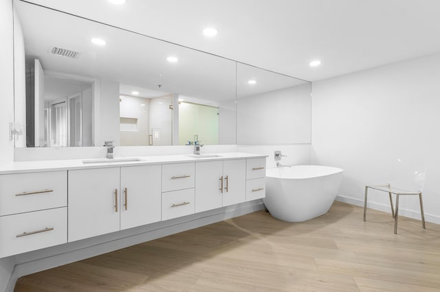3360 S Ocean Blvd Unit 5Fii, Palm Beach, FL 33480 - bathroom with double vanity, wood finished floors, a freestanding bath, recessed lighting, and baseboards