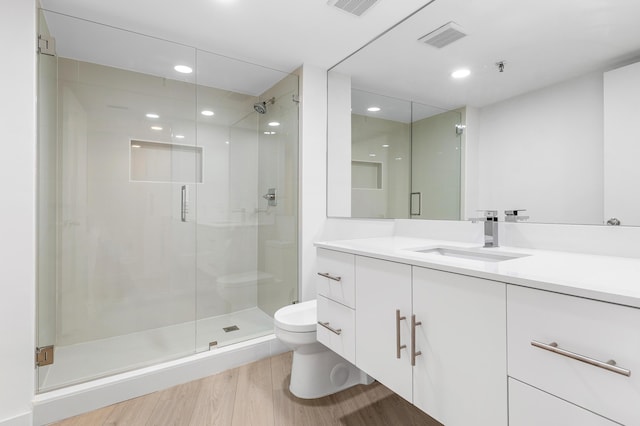 3360 S Ocean Blvd Unit 5Fii, Palm Beach, FL 33480 - bathroom featuring toilet, a stall shower, wood finished floors, vanity, and recessed lighting